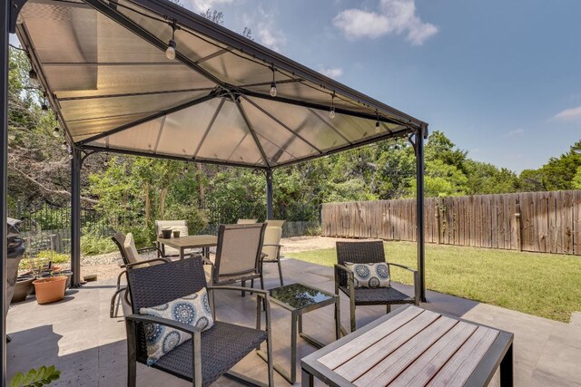8132 Amelia Cv, Austin, TX 78750 - fenced backyard with outdoor dining area and a patio