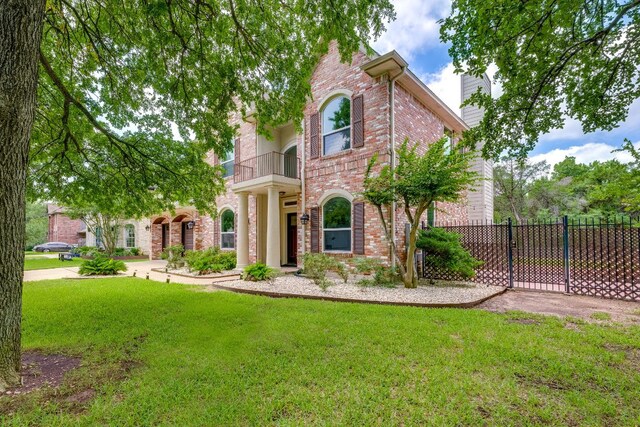 8132 Amelia Cv, Austin, TX 78750 - view of front of property featuring a balcony, brick siding, and a chimney