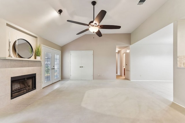 707 Clearwater Trl, Round Rock, TX 78664 - unfurnished living room with a ceiling fan, vaulted ceiling, french doors, carpet, and a tiled fireplace
