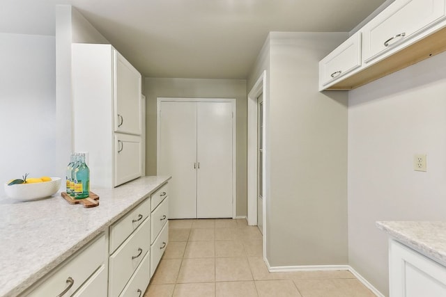 707 Clearwater Trl, Round Rock, TX 78664 - kitchen with white cabinets and light tile patterned flooring