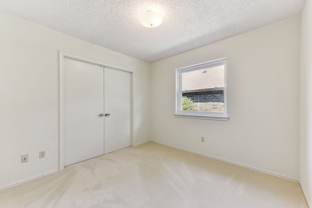 707 Clearwater Trl, Round Rock, TX 78664 - unfurnished bedroom with a textured ceiling, a closet, and carpet flooring