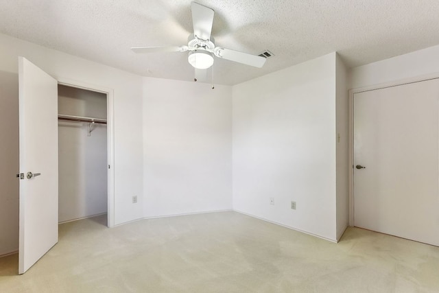 707 Clearwater Trl, Round Rock, TX 78664 - unfurnished bedroom with light colored carpet, a closet, a ceiling fan, and a textured ceiling