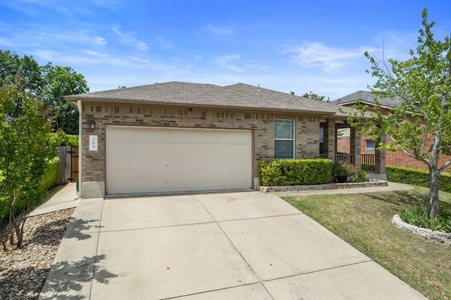 205 Banner Ave, Leander, TX 78641 - view of front of house featuring brick siding, concrete driveway, an attached garage, and roof with shingles