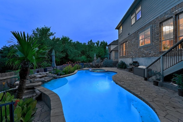 10220 N Chestnut Ridge Rd, Austin, TX 78726 - pool at dusk with a patio area, a fenced backyard, and a pool with connected hot tub