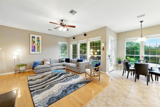 10220 N Chestnut Ridge Rd, Austin, TX 78726 - living room featuring a ceiling fan, baseboards, healthy amount of natural light, and light wood-style flooring