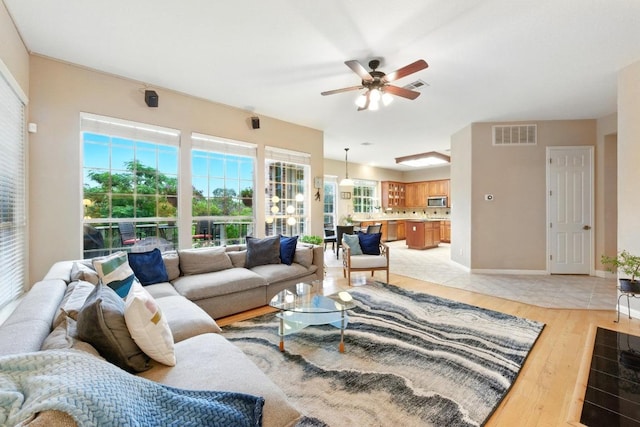 10220 N Chestnut Ridge Rd, Austin, TX 78726 - living area with ceiling fan, light wood-type flooring, and baseboards