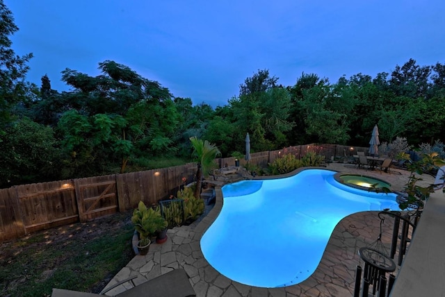 10220 N Chestnut Ridge Rd, Austin, TX 78726 - view of swimming pool with a patio, a fenced backyard, and a pool with connected hot tub