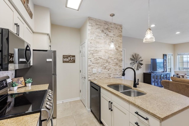 3404 American Dr Unit 1201, Lago Vista, TX 78645 - kitchen with stainless steel appliances, a sink, white cabinetry, light stone counters, and decorative light fixtures