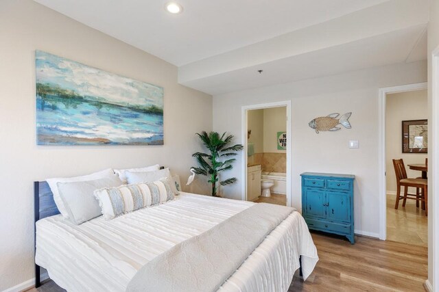 3404 American Dr Unit 1201, Lago Vista, TX 78645 - bedroom featuring ensuite bath, light wood-style flooring, and recessed lighting