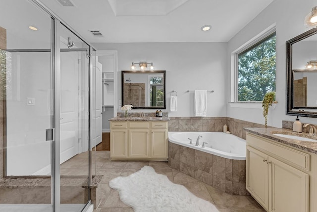 8316 Evelina Trl, Austin, TX 78737 - full bath with a shower stall, two vanities, a bath, tile patterned flooring, and recessed lighting