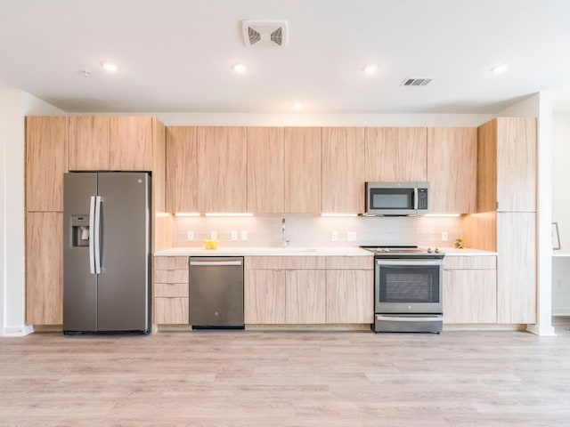 4802 S Congress Ave Unit 310, Austin, TX 78745 - kitchen with stainless steel appliances, light brown cabinets, light countertops, modern cabinets, and recessed lighting