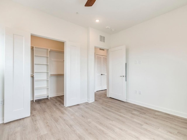 4802 S Congress Ave Unit 310, Austin, TX 78745 - unfurnished bedroom with wood finished floors, a walk in closet, a ceiling fan, and recessed lighting