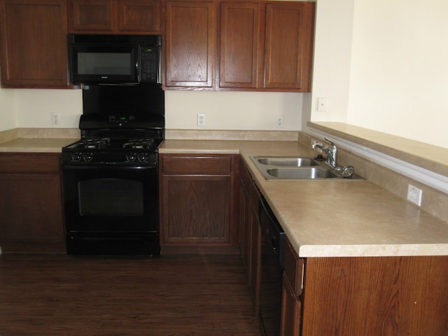 6708 Ferrystone Pass, Del Valle, TX 78617 - kitchen featuring black appliances, a peninsula, dark wood-type flooring, and light countertops
