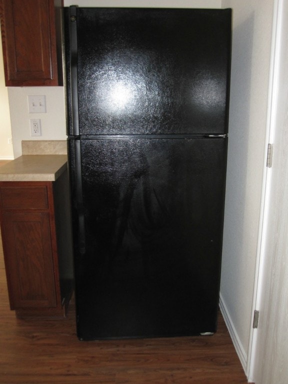 6708 Ferrystone Pass, Del Valle, TX 78617 - kitchen view of freestanding refrigerator, dark wood finished floors, and light countertops