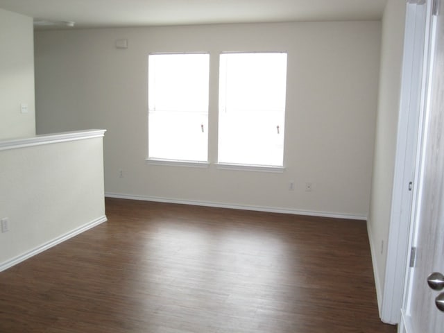 6708 Ferrystone Pass, Del Valle, TX 78617 - empty room featuring dark wood-style flooring and baseboards
