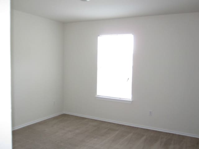 6708 Ferrystone Pass, Del Valle, TX 78617 - unfurnished room featuring light carpet and baseboards