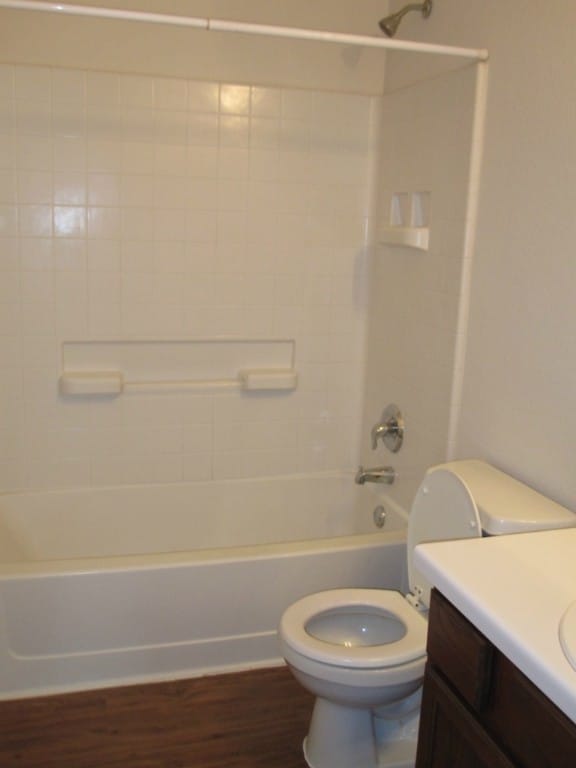 6708 Ferrystone Pass, Del Valle, TX 78617 - full bath featuring toilet, tub / shower combination, vanity, and wood finished floors