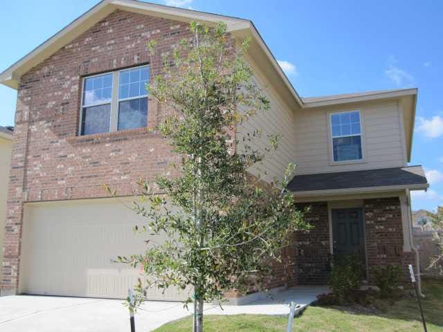 6708 Ferrystone Pass, Del Valle, TX 78617 - traditional home with brick siding, a garage, and concrete driveway