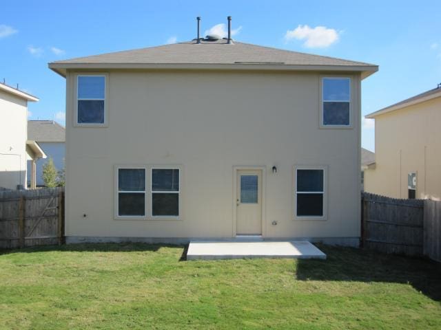 6708 Ferrystone Pass, Del Valle, TX 78617 - back of property with a patio and stucco siding