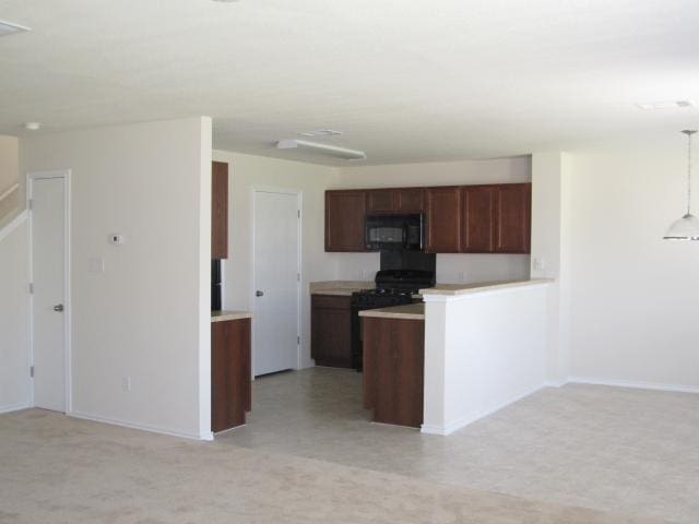 6708 Ferrystone Pass, Del Valle, TX 78617 - kitchen featuring black appliances, light countertops, and baseboards