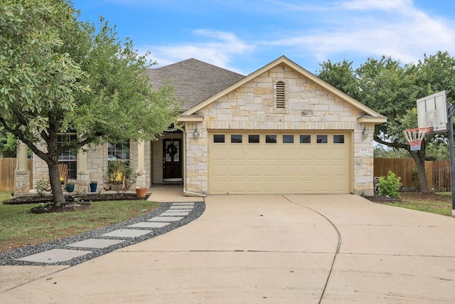 1918 Sand Creek Rd, Cedar Park, TX 78613 - view of front of home featuring stone siding, an attached garage, concrete driveway, and a shingled roof