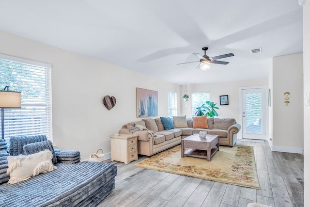1918 Sand Creek Rd, Cedar Park, TX 78613 - living room featuring light wood finished floors, a ceiling fan, and baseboards