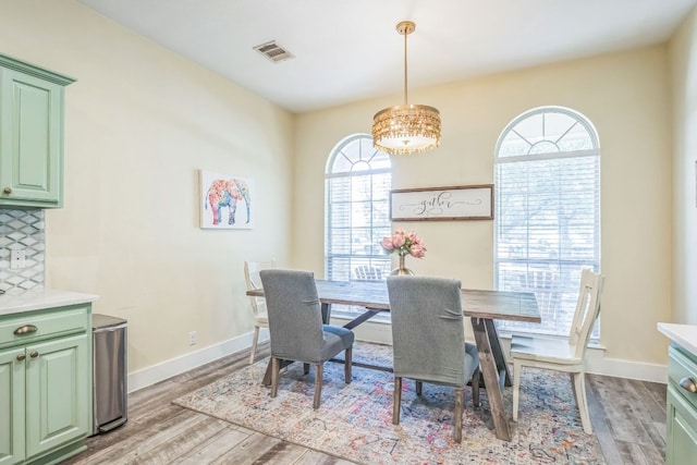 1918 Sand Creek Rd, Cedar Park, TX 78613 - dining space featuring light wood finished floors, baseboards, and a chandelier