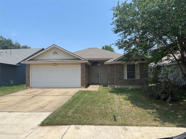 14502 Hartsmith Dr, Austin, TX 78725 - ranch-style house featuring brick siding, an attached garage, concrete driveway, and a front yard