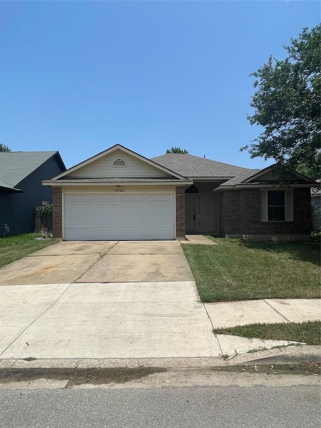 14502 Hartsmith Dr, Austin, TX 78725 - view of front of property featuring brick siding, a garage, concrete driveway, and a front yard
