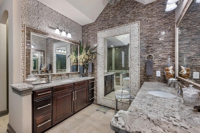 5700 Cherokee Draw Rd, Austin, TX 78738 - full bath with two vanities, a shower stall, tile patterned floors, and vaulted ceiling