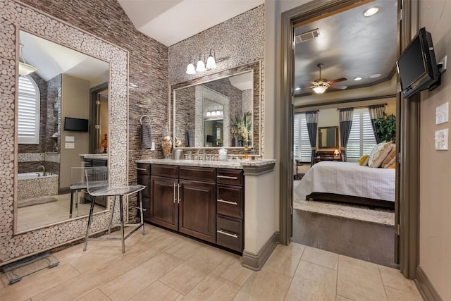 5700 Cherokee Draw Rd, Austin, TX 78738 - full bathroom featuring ceiling fan, vanity, a bath, ensuite bathroom, and tile patterned flooring