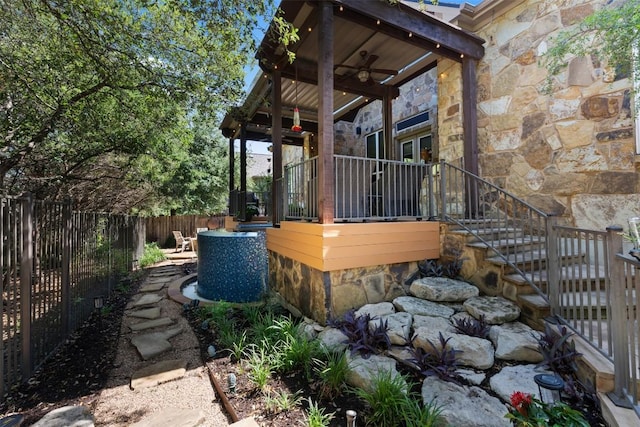 5700 Cherokee Draw Rd, Austin, TX 78738 - view of side of home featuring stone siding, a ceiling fan, and stairs