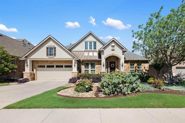 5700 Cherokee Draw Rd, Austin, TX 78738 - view of front of house with stone siding, driveway, stucco siding, a standing seam roof, and an attached garage