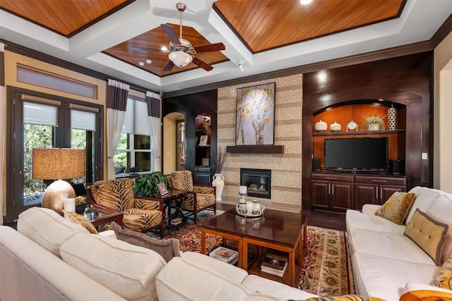 5700 Cherokee Draw Rd, Austin, TX 78738 - living area with a tiled fireplace, a ceiling fan, coffered ceiling, crown molding, and beam ceiling