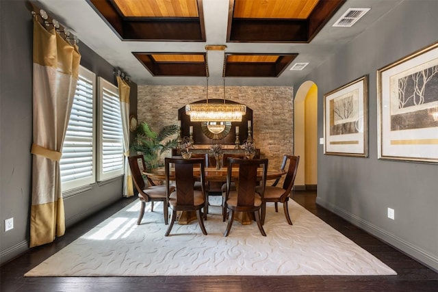 5700 Cherokee Draw Rd, Austin, TX 78738 - dining space featuring a chandelier, arched walkways, dark wood-style floors, and coffered ceiling