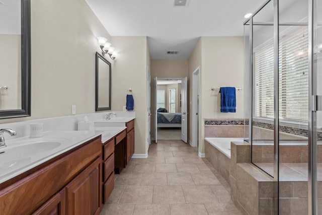2700 Outlook Ridge Loop, Leander, TX 78641 - bathroom featuring ensuite bath, double vanity, a bath, and plenty of natural light