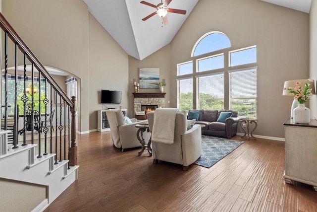 2700 Outlook Ridge Loop, Leander, TX 78641 - living room with stairway, ceiling fan, high vaulted ceiling, a stone fireplace, and dark wood finished floors