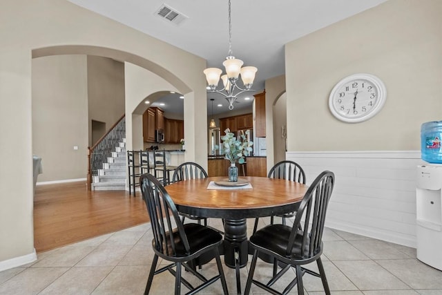 2700 Outlook Ridge Loop, Leander, TX 78641 - dining space featuring light tile patterned flooring, a chandelier, stairs, arched walkways, and recessed lighting