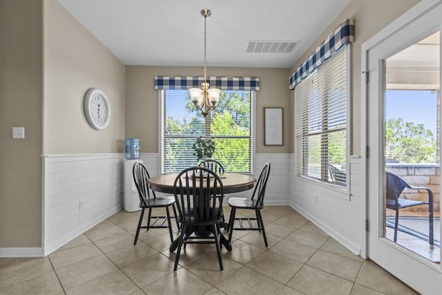 2700 Outlook Ridge Loop, Leander, TX 78641 - dining space with a chandelier, wainscoting, and light tile patterned flooring