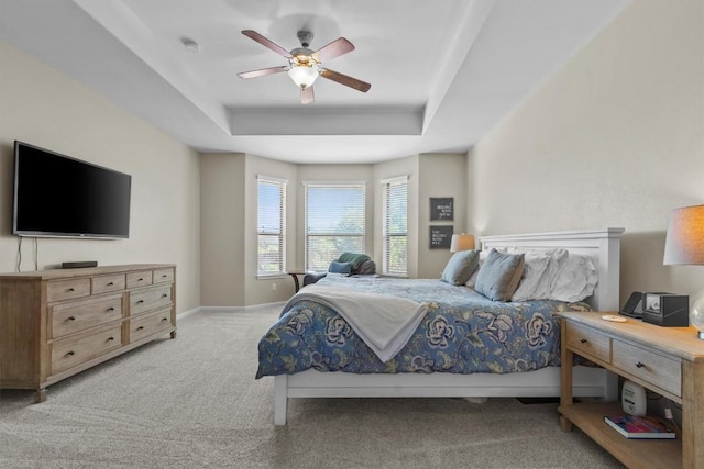 2700 Outlook Ridge Loop, Leander, TX 78641 - bedroom with light colored carpet, a tray ceiling, and ceiling fan