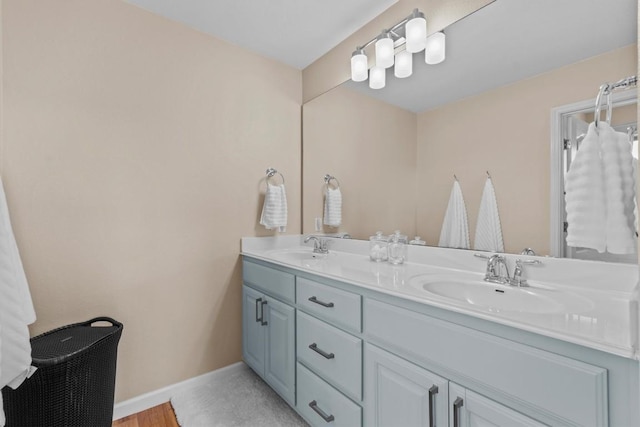 2700 Outlook Ridge Loop, Leander, TX 78641 - full bathroom featuring double vanity and baseboards