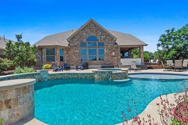 2700 Outlook Ridge Loop, Leander, TX 78641 - view of swimming pool featuring a patio, a pool with connected hot tub, and outdoor dining space