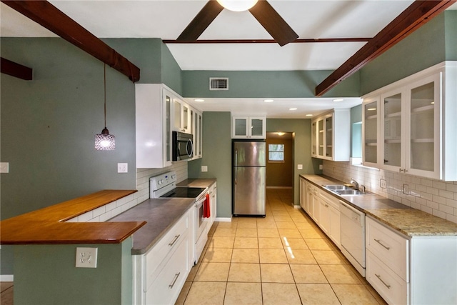 17903 Lafayette Park Rd, Jonestown, TX 78645 - kitchen featuring stainless steel appliances, tasteful backsplash, a sink, glass insert cabinets, and beam ceiling