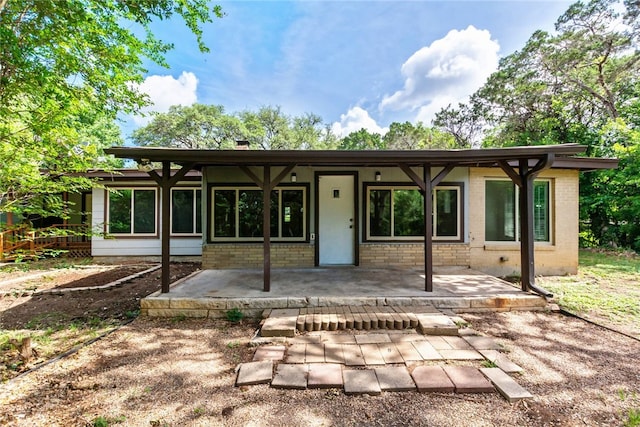 17903 Lafayette Park Rd, Jonestown, TX 78645 - rear view of house featuring brick siding and a patio