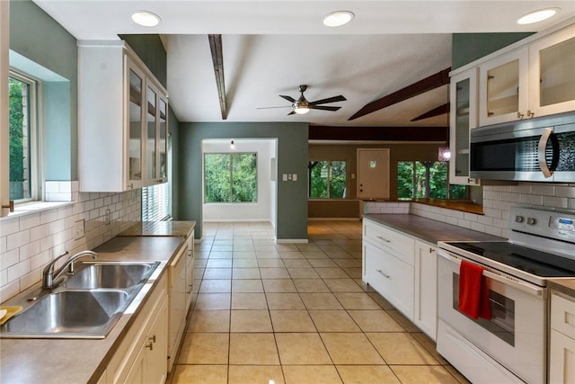 17903 Lafayette Park Rd, Jonestown, TX 78645 - kitchen featuring white electric stove, stainless steel microwave, a sink, backsplash, and recessed lighting