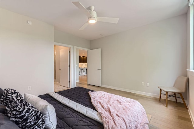 900 S 1st St Unit 212, Austin, TX 78704 - bedroom with light wood-style flooring, baseboards, and ceiling fan