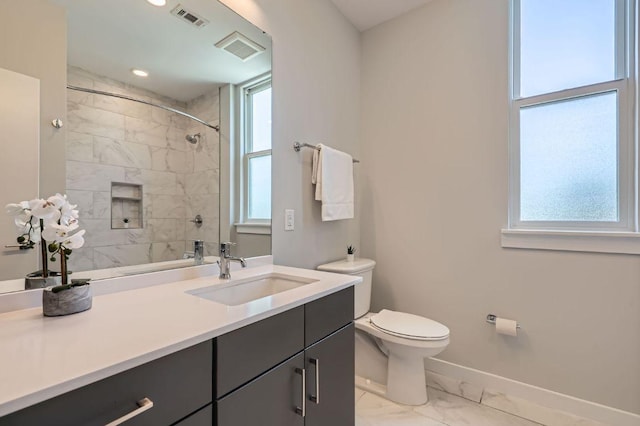 900 S 1st St Unit 212, Austin, TX 78704 - full bathroom featuring marble finish flooring, baseboards, vanity, toilet, and a tile shower