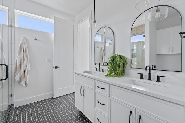 6410 Cannonleague Dr Unit 1, Austin, TX 78745 - bathroom featuring double vanity, a stall shower, baseboards, and tile patterned flooring