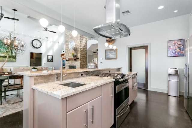 165 Highridge Ln, Fredericksburg, TX 78624 - kitchen featuring stainless steel gas stove, island exhaust hood, ceiling fan, open floor plan, and backsplash