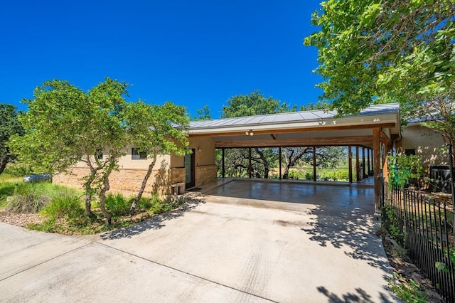 165 Highridge Ln, Fredericksburg, TX 78624 - view of front of house featuring driveway, a carport, a standing seam roof, and stucco siding